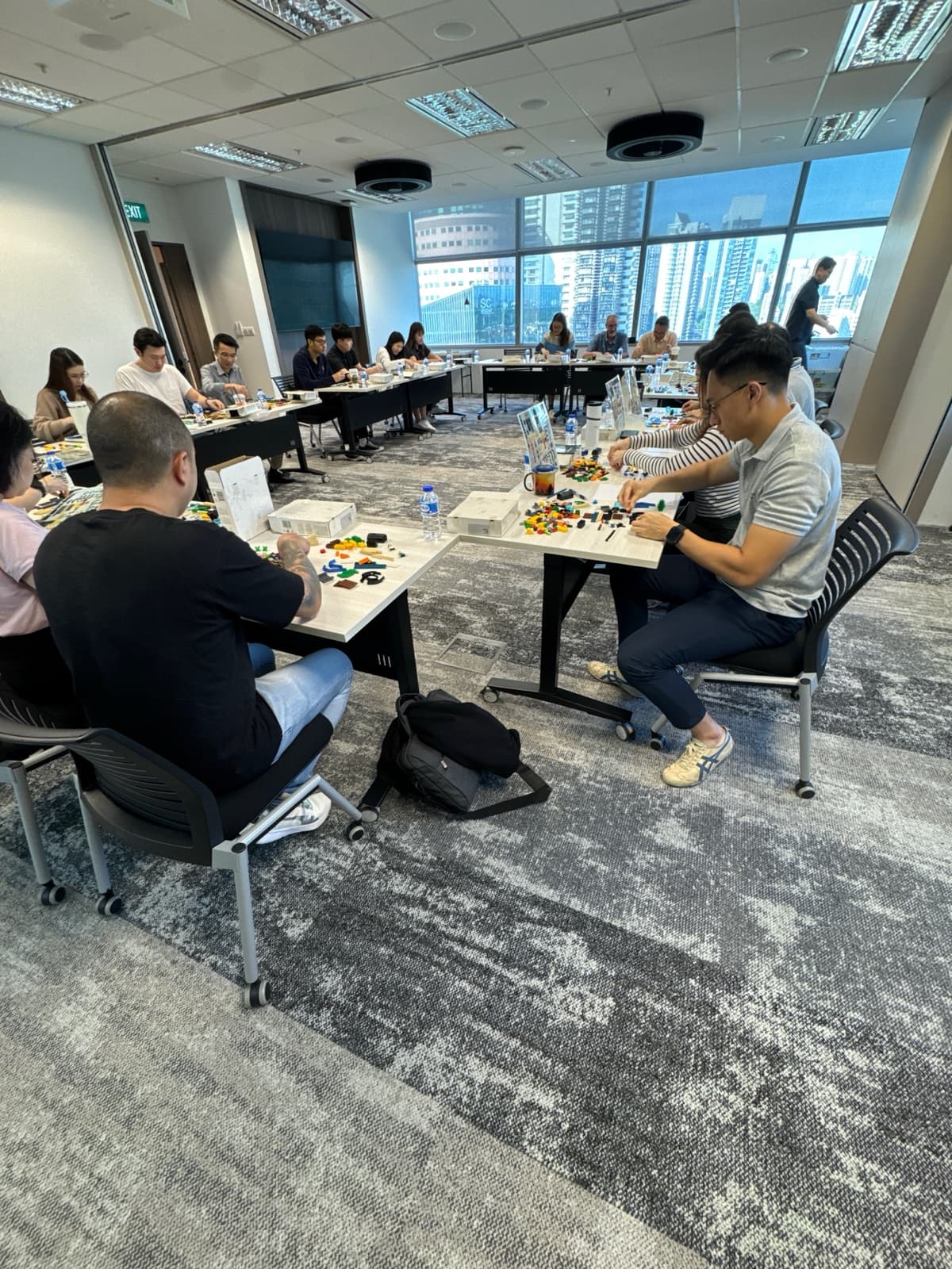 A room of executives working through a structured session, capability built across a whole team