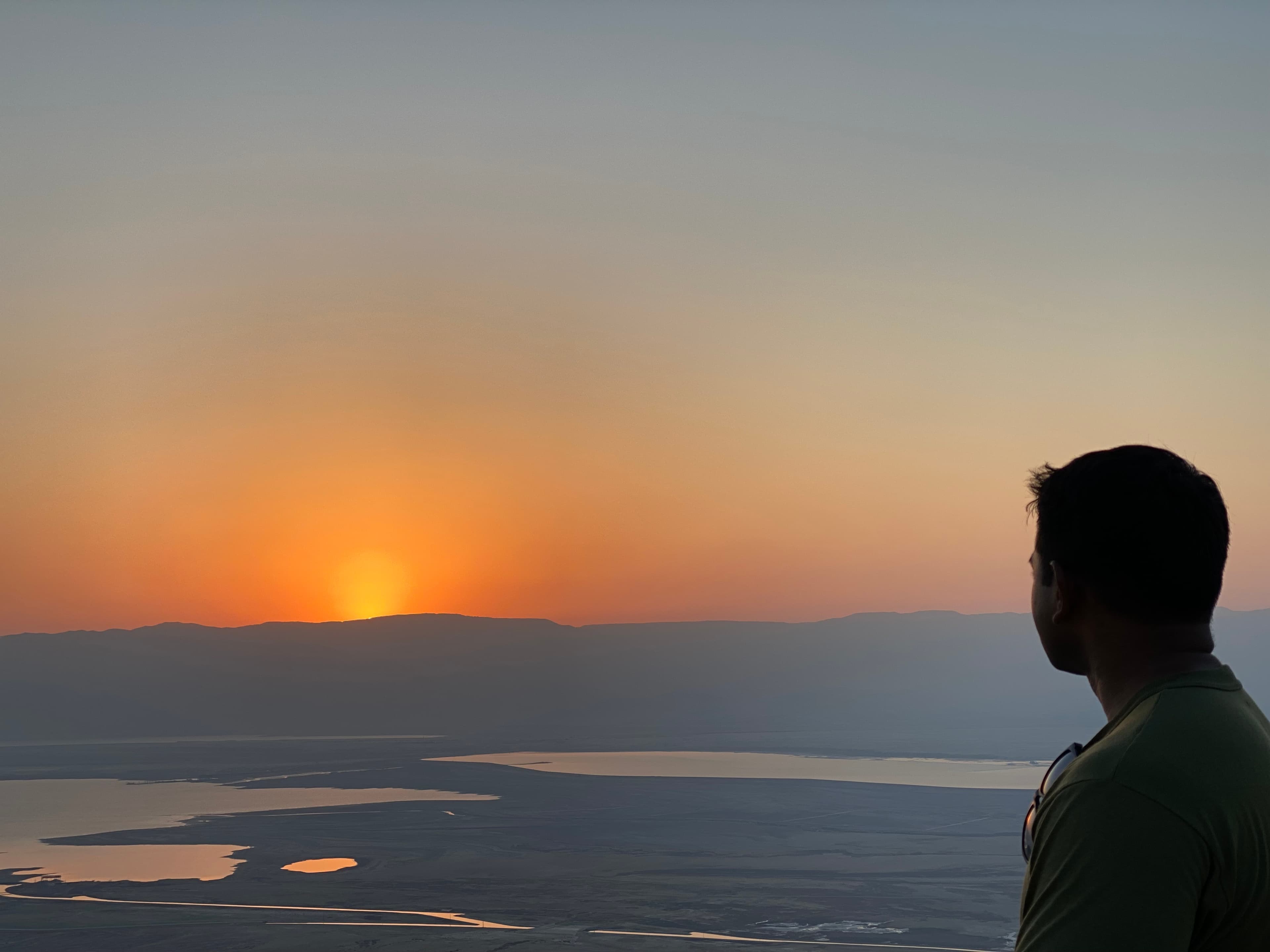 A lone figure watching the sunset — clarity comes from stillness