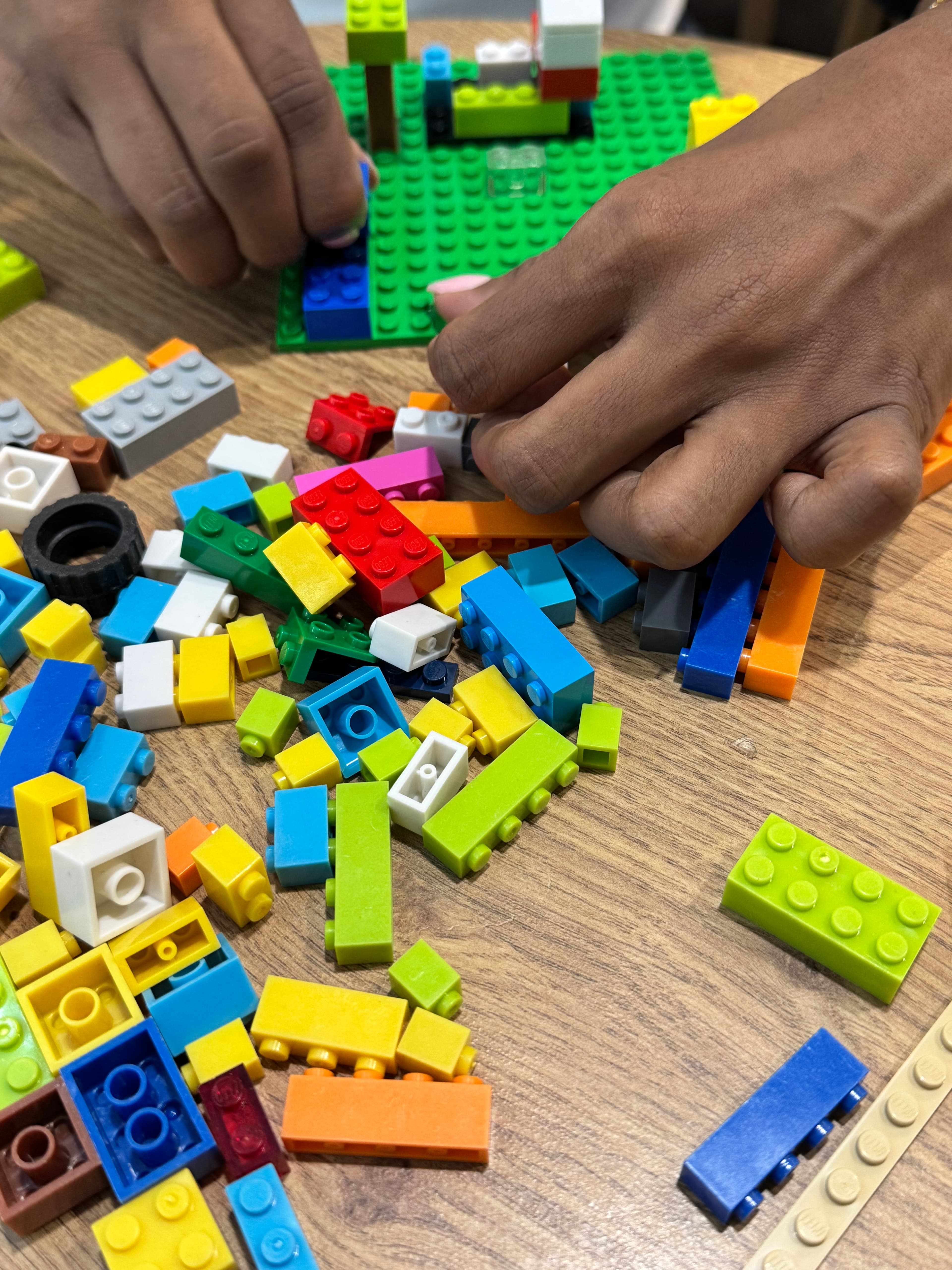 Hands building with LEGO Serious Play