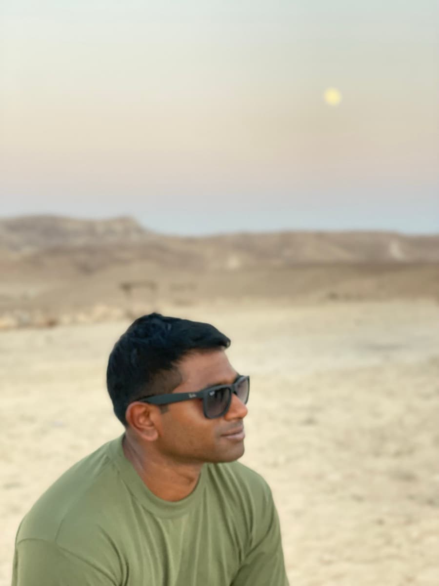 Prathap in contemplative profile at desert dusk, the inner work at the centre of executive coaching